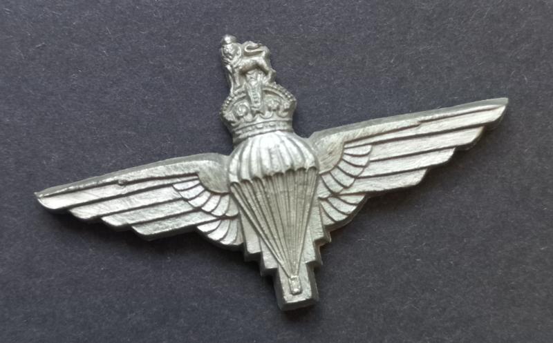 A good (unfortunately missing its two brass blade fittings) example of a plastic cap badge to The Parachute Regiment