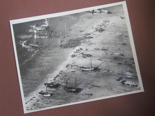 A unusual and difficult to find original 'press-release' photograph depicting British Commando Troops of No.6 Commando returning from a raid during 'Operation Bristle' on the France coast on the night of 3/4 June 1942