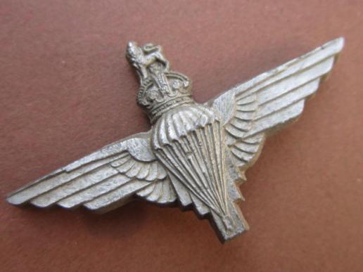 A perfect and issued example of a plastic cap badge to The Parachute Regiment