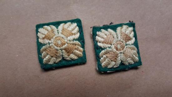 A matching set of two British army Officers pips on a dark green backing
