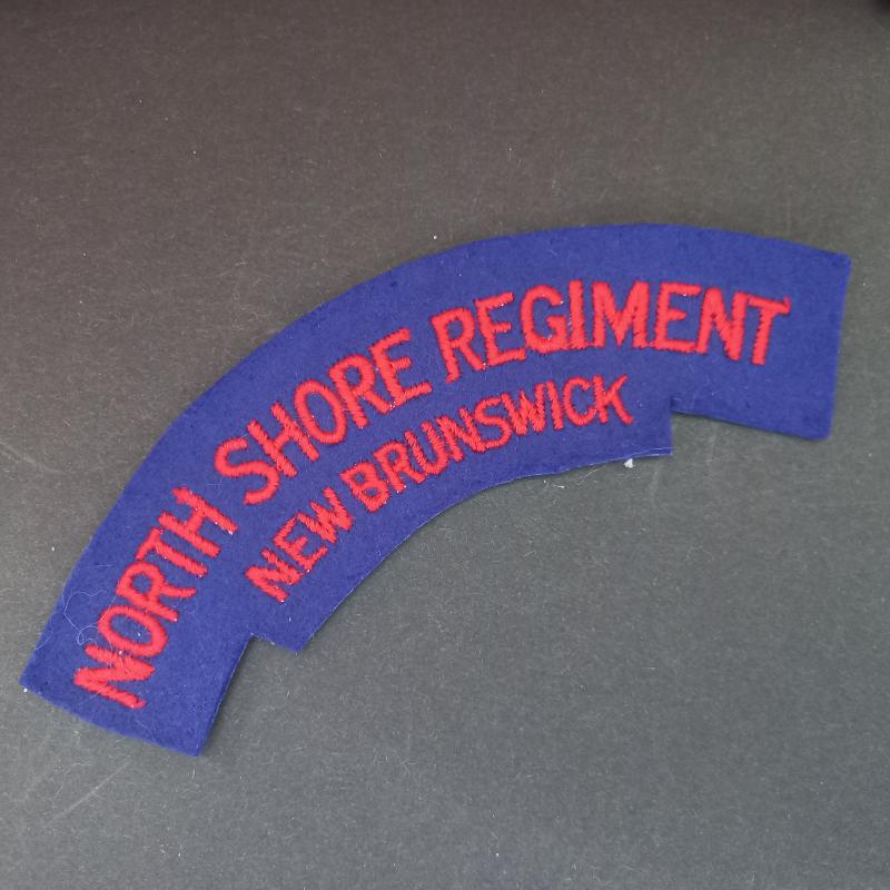 A superb made - un-issued - British made (with its typical paste i.e glue backing) Canadian North Shore Regiment New Brunswick shoulder title