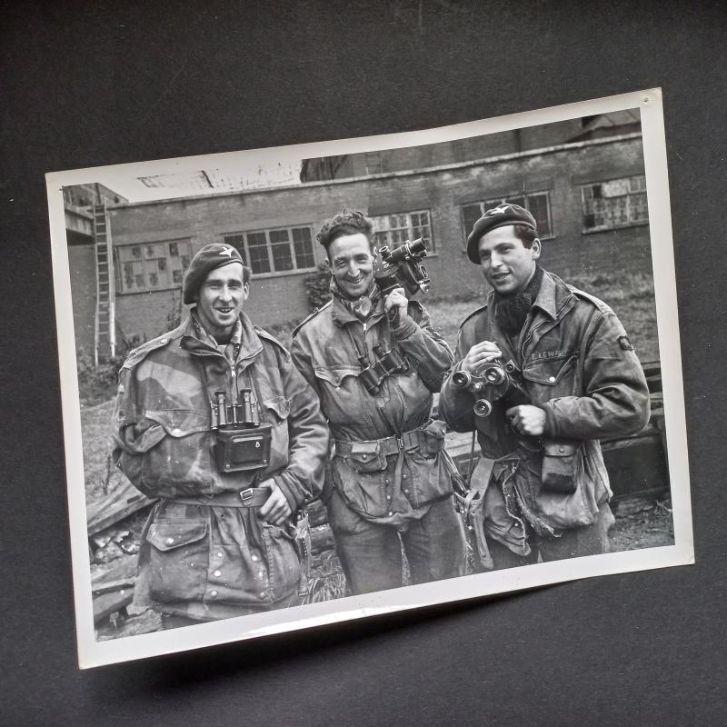 A unusual and attractive well known re-print of a IWM (Imperial War Museum) photograph depicting three members of the AFPU (Army Film and Photo Unit) Lewis, Smith and Walker