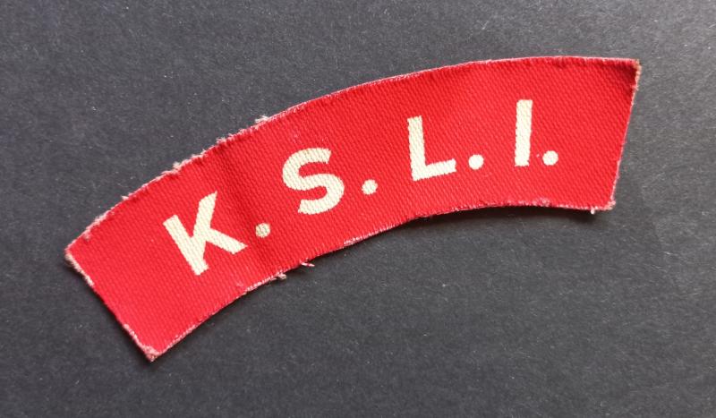 A great - un-issued - printed K.S.L.I. (Kings Shropshire Light Infantry) shoulder title