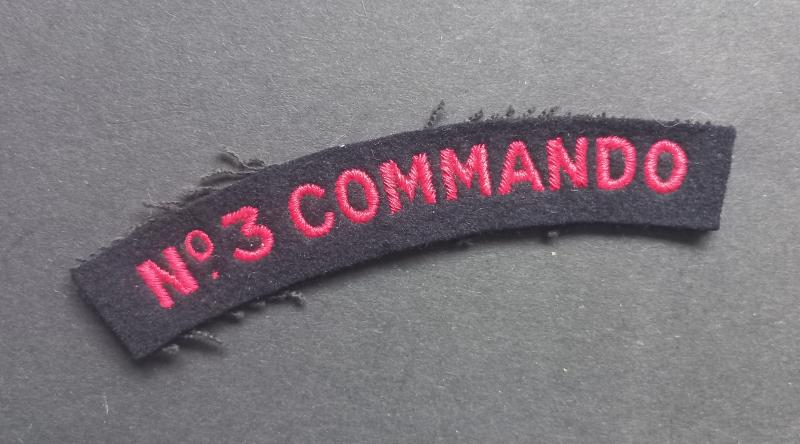 A nice un-issued red on black embroided - regrettably single - Number 3 Commando shoulder title