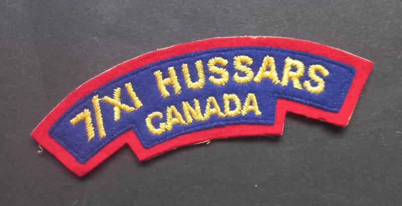 A nice un-issued British made (white backing) Canadian 7th/XI Hussars Regiment of Canada 11th VII Cloth shoulder title