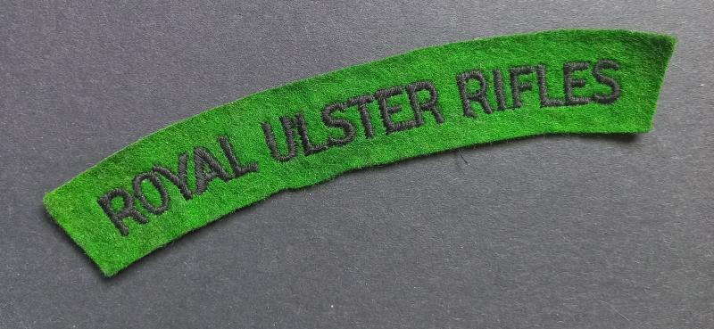 A attractive - un-issued - Royal Ulster Rifles black on green embroided shoulder title