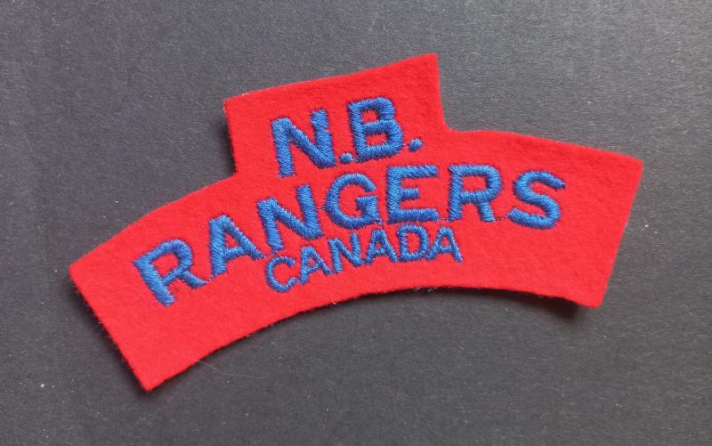 A nice un-issued British made Canadian N.B. (New Brunswick) Rangers embroided shoulder title