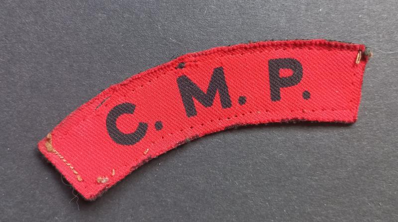 A attractive (unfortnately damage) printed C.M.P. (Corps of Military Police) shoulder title
