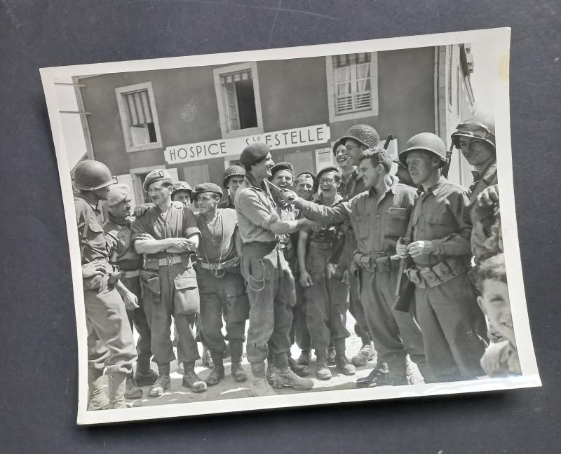 A attractive official US Signal Corps 'Press Release' (large 25.9cm x 20.2cm) photograph showing British S.A.S. (Special Air Service) troops after Operation HAFT meeting up with American troops some were in France
