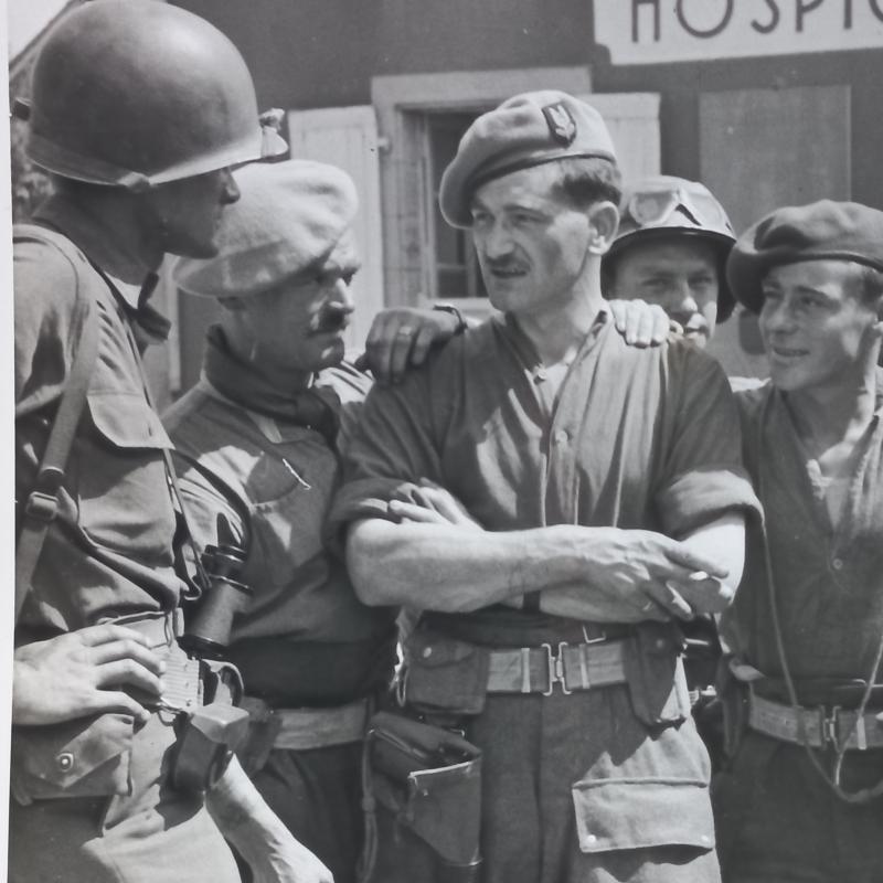 A attractive official US Signal Corps 'Press Release' (large 25.9cm x 20.2cm) photograph showing British S.A.S. (Special Air Service) troops after Operation HAFT meeting up with American troops some were in France