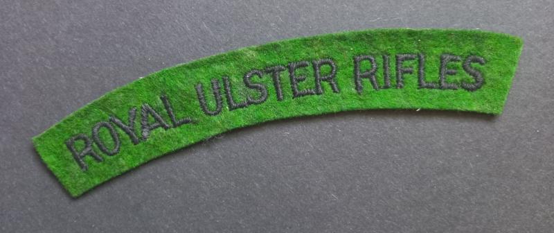A attractive - un-issued - Royal Ulster Rifles black on green embroided shoulder title