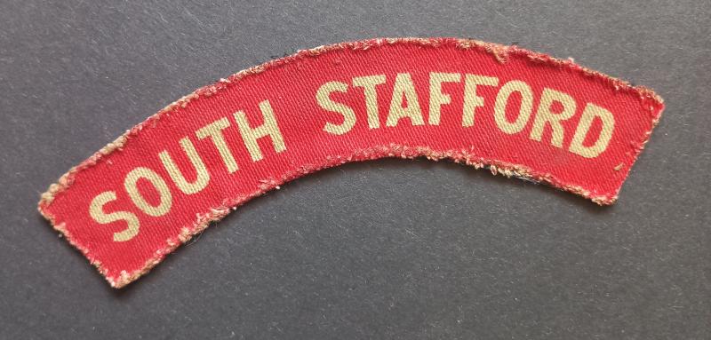 A attractive - albeit regrettably single - white on red printed South Stafford shoulder title