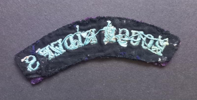 A superb early war time (regrettably single) embroided British made Rough Riders shoulder title