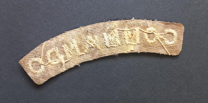A superb - albeit regrettably single - early white on black embroided commando shoulder title