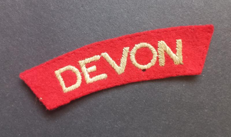 A nice - issued standard embroided - Devonshire Regiment shoulder title